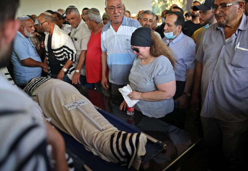 Israeli relatives attend the funeral of Yigal Yehoshua in the city of Modiin. The Israeli man, 56, who was beaten in the city of Lod, died in hospital, police said. AFP