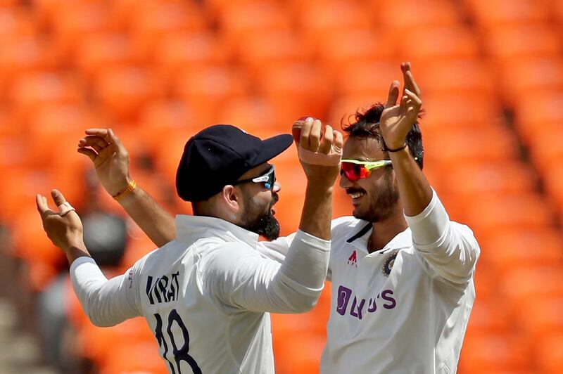 India's Axar Patel, right, celebrates with captain Virat Kohli after the dismissal of England's Ben Stokes. AP