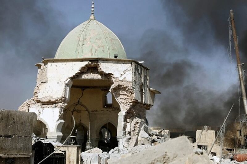 Smoke billows from the ruined Grand al-Nuri Mosque after it was retaken by the Iraqi forces at the Old City in Mosul, Iraq June 29, 2017. Erik De Castro / Reuters