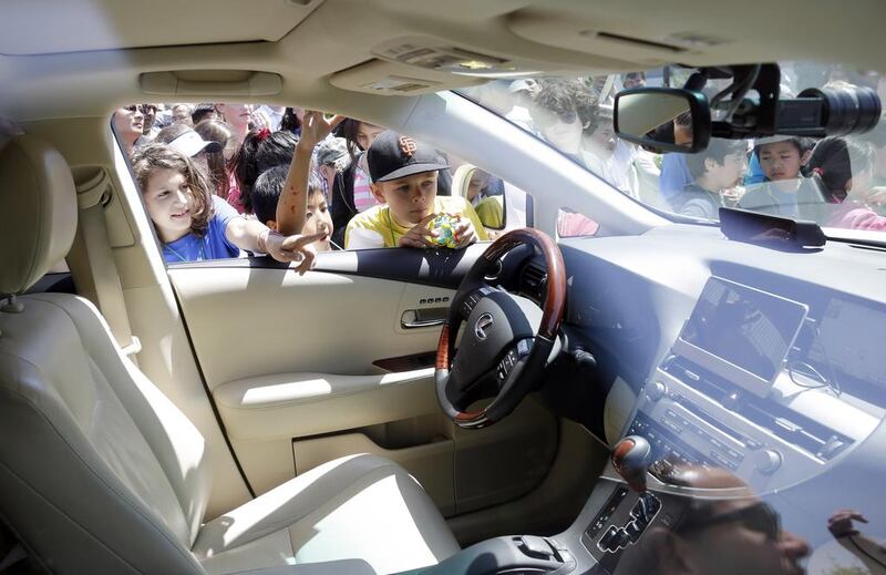 Children look inside the self-driving car at Google headquarters in Mountain View, California. AP Photo