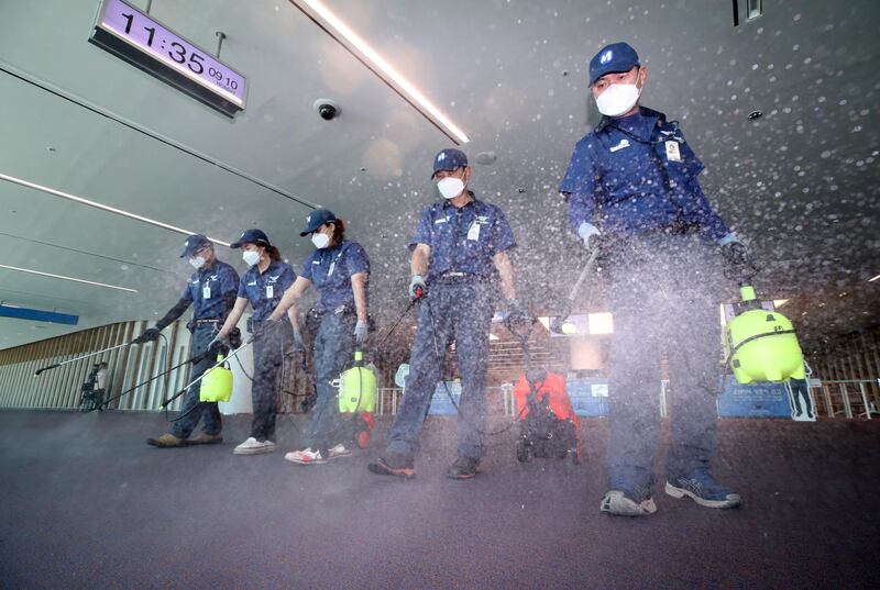 Sanitation workers disinfect the second terminal of Incheon airport in South Korea. EPA