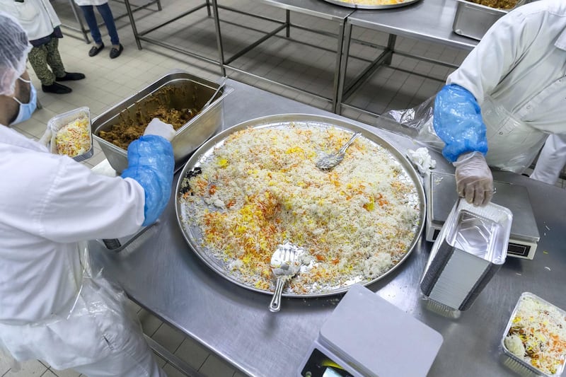DUBAI, UNITED ARAB EMIRATES. 27 APRIL 2020. Dar Al Ber Iftar meal preparation for handing out as part of their charity work at the Modern Bakery in Al Quoz. Bulk prepared food is packed for individual consumption. (Photo: Antonie Robertson/The National) Journalist: None. Section: National.