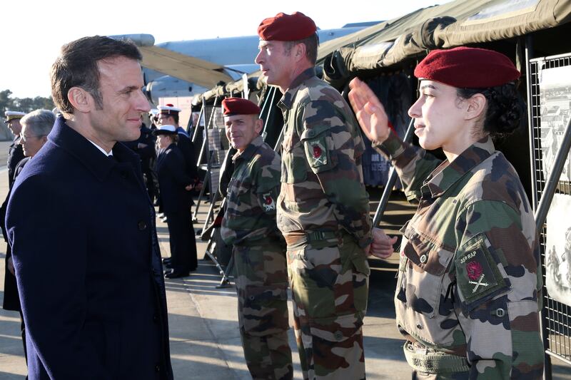 A soldier salutes French President Emmanuel Macron at the Mont-de-Marsan airbase, where he proposed a substantial boost in military spending. AP