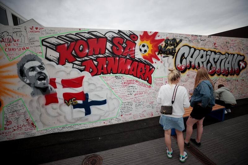 Fans write messages of support for Denmark midfielder Christian Eriksen at a fanzone in Copenhagan. Reuters