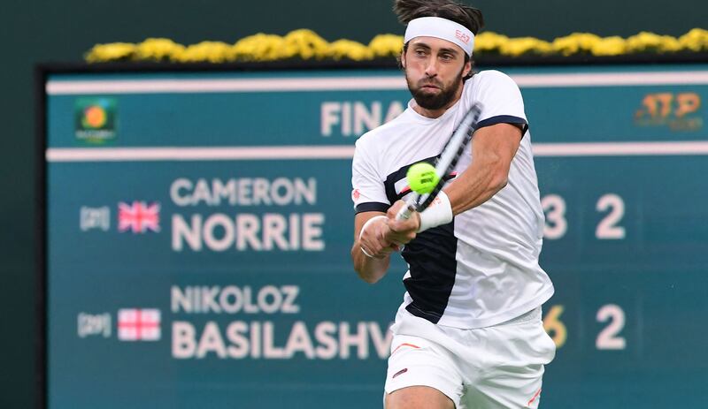 Nikoloz Basilashvili of Georgia hits a backhand return to Cameron Norrie of Great Britain. AFP