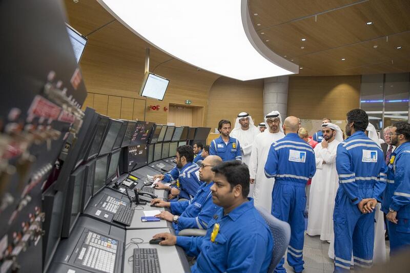 Sheikh Mohammed bin Zayed, centre, Crown Prince of Abu Dhabi and Deputy Supreme Commander of the UAE Armed Forces, speaks with Al Hosn gas employees. Ryan Carter / Crown Prince Court - Abu Dhabi