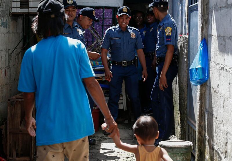epa06483244 Philippine police prepare to talk to a person of interest (front-L) in a police anti-illegal drugs campaign at a local community in Quezon City, east of Manila, Philippines, 29 January 2018. The police force on 29 January revived its anti-drug campaign called Oplan Tokhang (Knock and Plead), an operation that figured in controversy and received local and international criticism due to alleged links to cases of human rights violations and extrajudicial killings. Some revisions to Oplan Tokhang include conducting the campaign only during daytime and never on weekends.  EPA/ROLEX DELA PENA