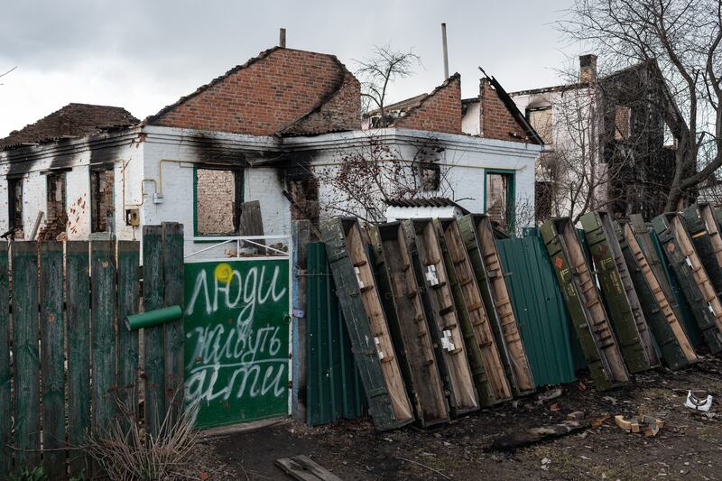 Another writing on the fence of a destroyed building, in Andriivka, reads 'People children live here'. Getty Images
