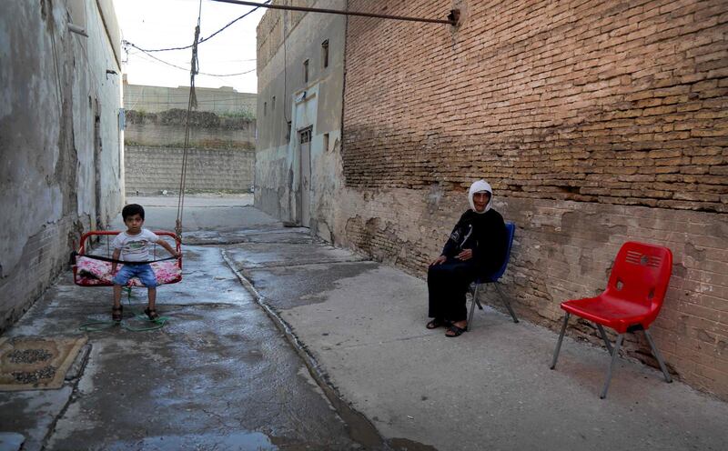 An Iraqi Kurdish woman and her relative outside their home in Erbil, the capital of the northern Iraqi Kurdish autonomous region.  AFP