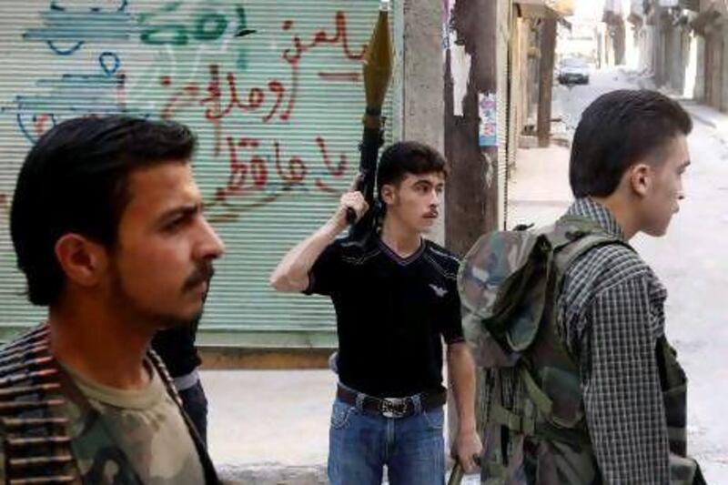 A Free Syrian Army fighter readies a rocket-propelled grenade launcher in the Salah Al Din neighbourhood of central Aleppo. A full-scale assault on Syria's commercial heartland seems likely by a regime force of 20,000 soldiers, backed by tanks, artillery, helicopter gunships and attack jets.