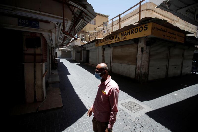 A man walks past closed shops, as the country goes into a two-week semi-lockdown due to high number of coronavirus disease (COVID-19) cases and deaths, in Manama, Bahrain, June 3, 2021. REUTERS/Hamad I Mohammed