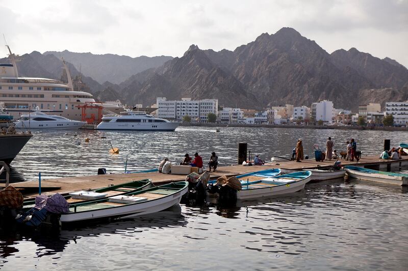 Backed by the white buildings that line the corniche of Mutrah district, fishermen and delivery staff work near the Mina Sultan Qaboos in downtown Muscat, the capital of the Sultanate of Oman on Wednesday, Oct. 12, 2011. (Silvia Razgova / The National)

