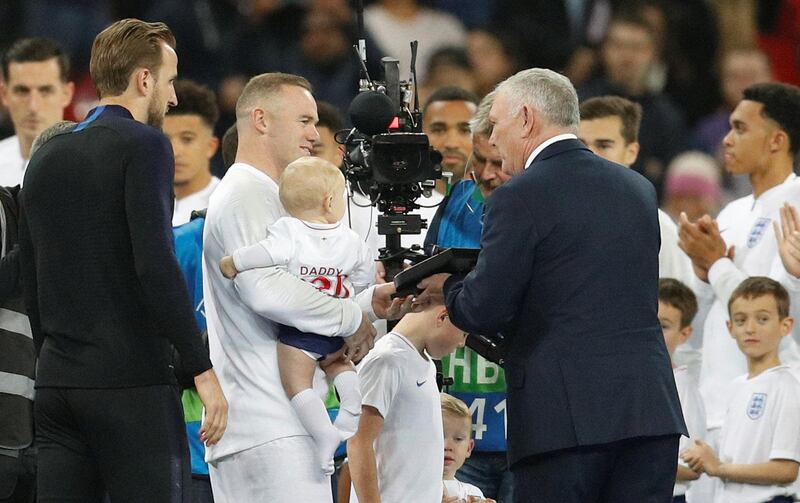 FA chairman Greg Clarke makes a presentation to England's Wayne Rooney before the match. REUTERS