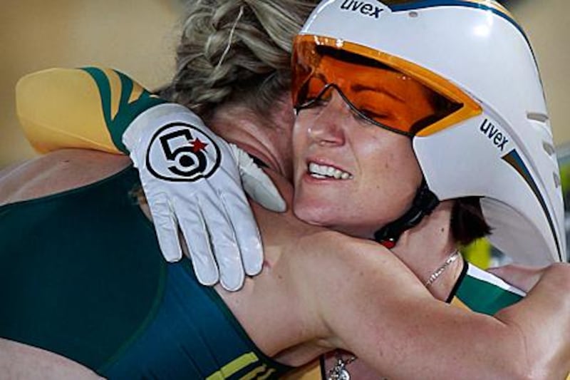 Australia's gold medal cyclist Anna Meares, right, hugs teammate and silver medallist Kaarle McCulloch after the  women's 500m time trial.