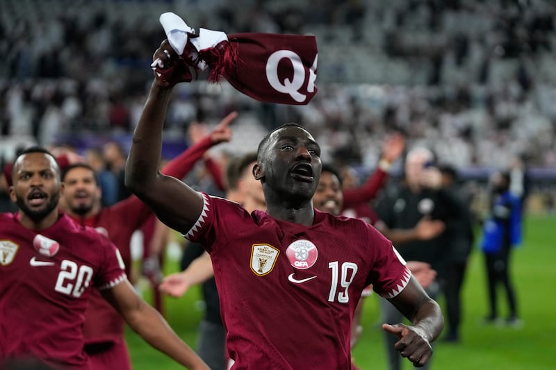 Qatar's Almoez Ali, right, celebrates with teammates after the match. AP