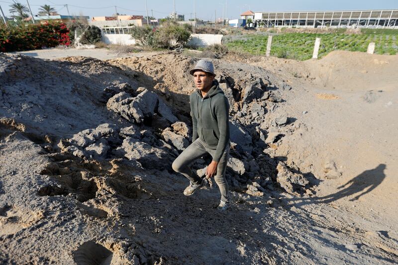 A Palestinian man stands at the site of an Israeli air strike carried out in Gaza City. Reuters