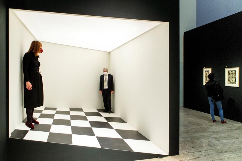 Visitors pose inside an installation on the opening day of an exhibition devoted to Dutch artist Maurits Cornelis Escher at the Gothic Atarazanas Centre in Barcelona, Spain. EPA