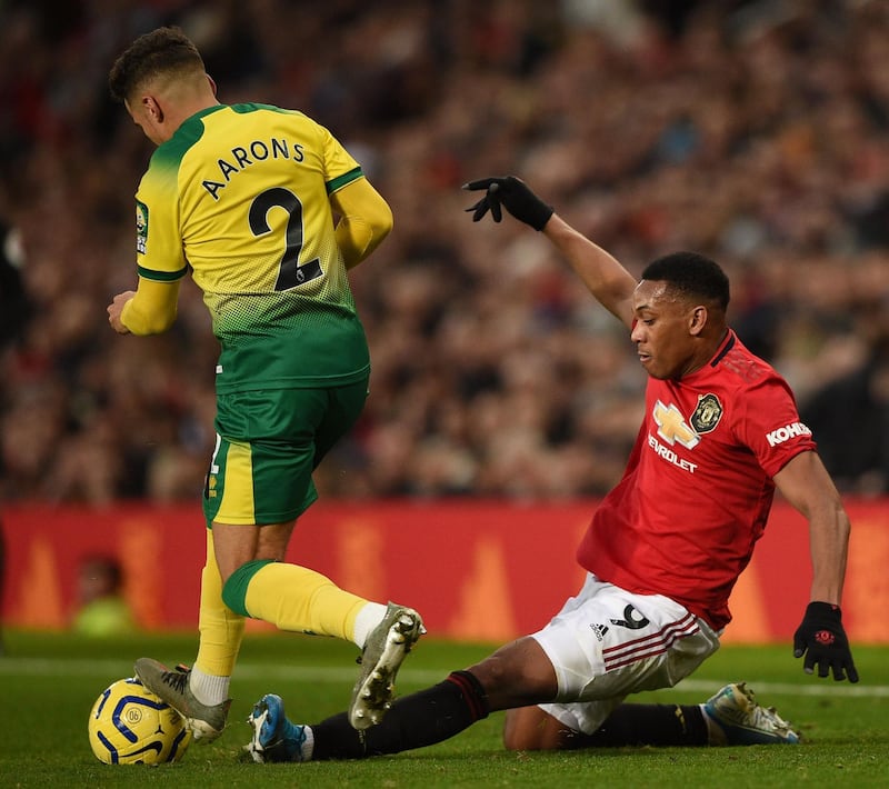 Manchester United's Anthony Martial, right, tackles Norwich City's Max Aarons. AFP