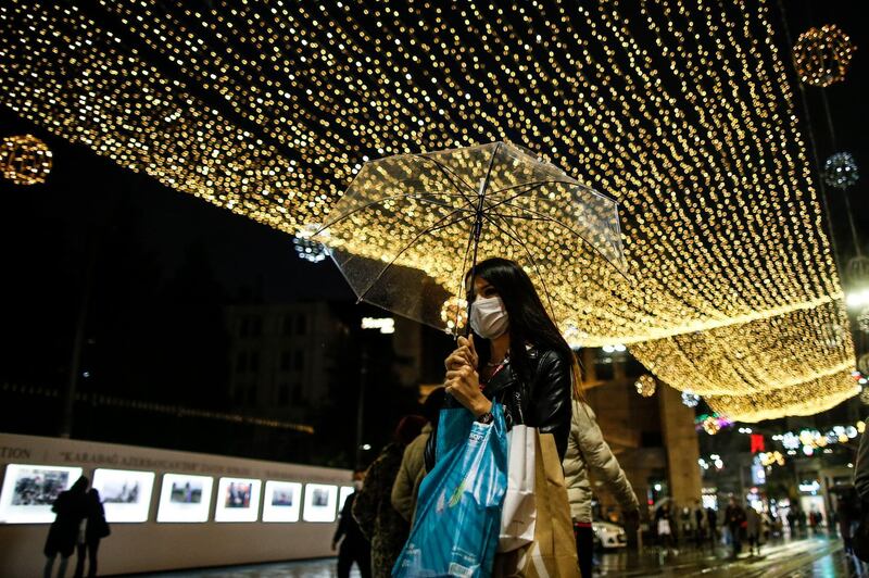 People walk on Istiklal street, the main shopping street in Istanbul, a few hours before the lockdown, part of the new measures to try curb the spread of the coronavirus. AP Photo