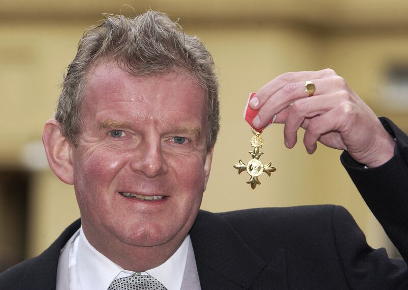 Motson receives an OBE at Buckingham Palace in 2001. PA