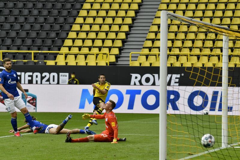 BUNDESLIGA RETURNS TO ACTION - WEEK 1: BORUSSIA DORTMUND 4 SCHALKE 0. Raphael Guerreiro scores Dortmund's second goal at Westfalenstadion on May 16, 2020. Getty