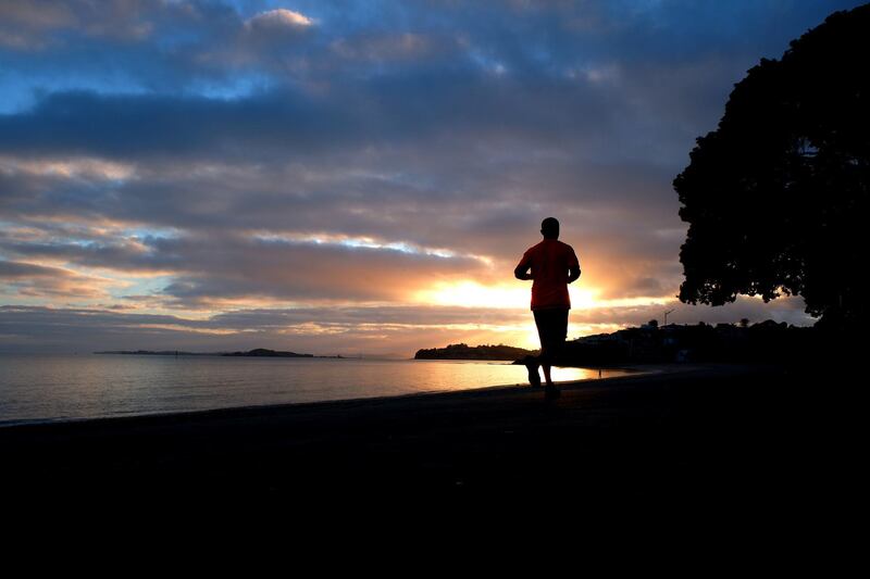 A man runs along Tamaki Drive in Auckland, New Zealand. Getty Images