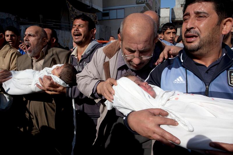 The bodies of Palestinian children Suhaib HIhazi, 2  and Mohamed, 4 , are carried by family members during their funeral procession in Beit Lahiya , Gaza November 20,2012 .An explosive device hit the family's home last night seriously wounding the mother and killing the father and two children . (Photo by Heidi Levine/Sipa Press for The National)