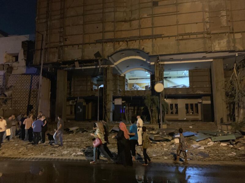 People look on at the damage left by a fire from a blast outside the National Cancer Institute, Cairo, Egypt. EPA