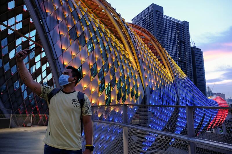 A man takes a selfie photograph at the Saloma Link bridge in Kuala Lumpur, Malaysia. Bloomberg