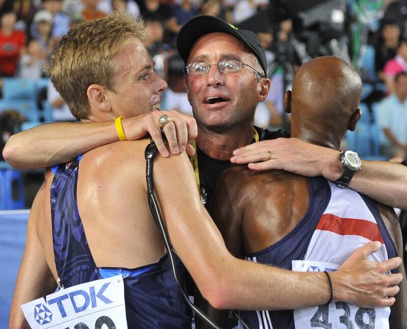 Coach Alberto Salazar, centre, hugs Britain's Mo Farah, right, and US athlete Galen Rupp following the men's 5,000-metre final at the International Association of Athletics Federations (IAAF) World Championships in Daegu. Britain's Olympic and world champion Mo Farah said on June 6, 2015 he had no plans to end his relationship with Salazar despite allegations the American had encouraged his athletes to use illegal substances. A BBC documentary, broadcast on Wednesday, alleges Salazar, 56, had encouraged athletes including America's Olympic 10,000m silver medallist Galen Rupp, a training partner of Farah's, to use illegal substances. Both Salazar and Rupp have insisted they are innocent of the allegations. Juon Yeon-Je / AFP

