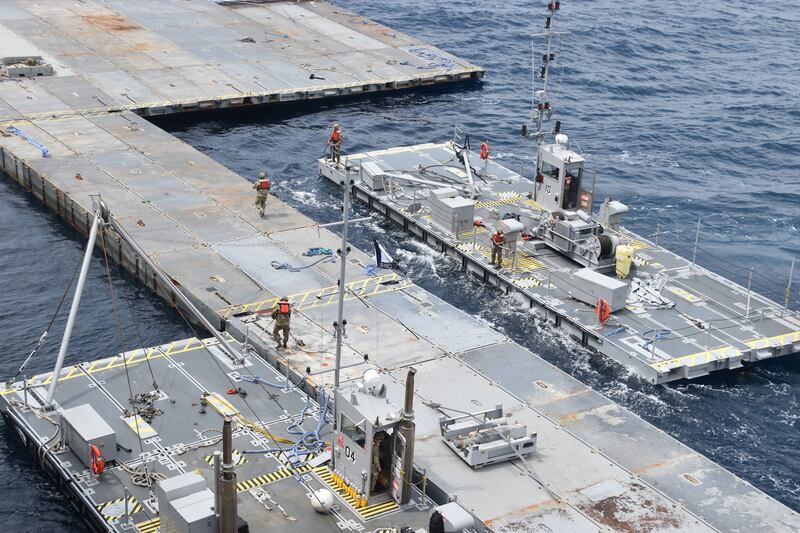 US soldiers and sailors assemble the floating pier in the Mediterranean Sea. US Central Command / Reuters
