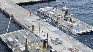 US soldiers and sailors assemble the floating pier in the Mediterranean Sea. US Central Command / Reuters