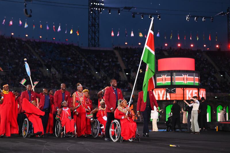 Ferdinand Omanyala and Carolina Wanjira, flagbearers of Team Kenya, lead their team. Getty Images