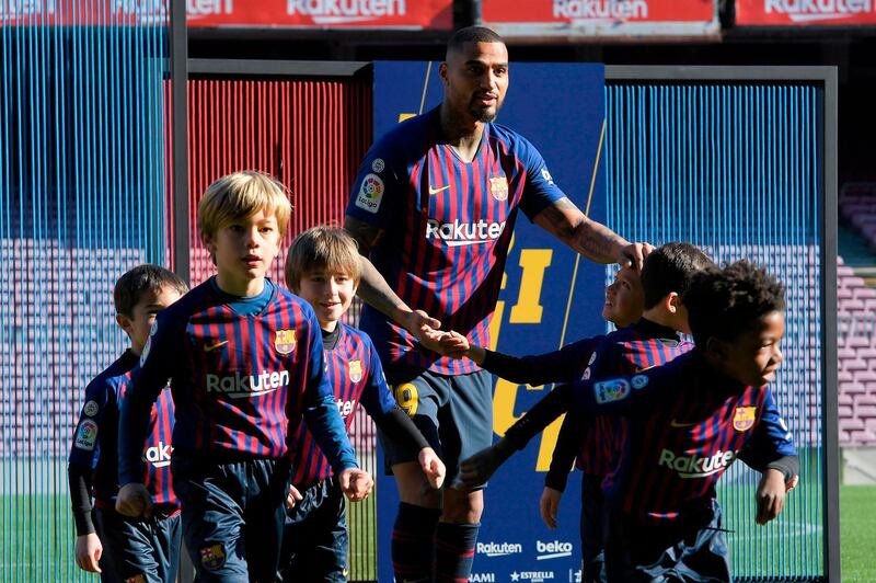 Barcelona's new Ghanaian forward Kevin-Prince Boateng, centre, poses with children during his official presentation at Camp Nou. AFP