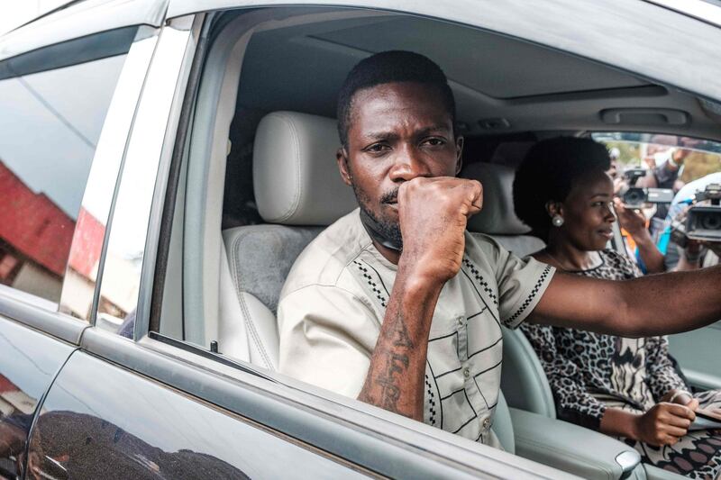 Bobi Wine gestures as he leaves after casting his pictures at a polling station in Magere, Uganda. AFP