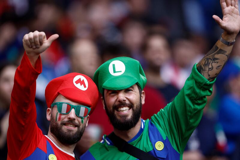 Italy supporters dressed as Mario and Luigi pose for pictures before the start of the Euro 2024 Group B match between Spain and Italy, in Gelsenkirchen, Germany. AFP