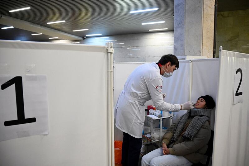 A woman undergoes a rapid antigen test  at a testing centre in a metro station in Moscow, Russia. The country is recording more than 40,000 new Covid-19 cases a day. AFP