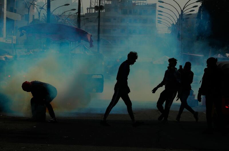 Security forces fire tear gas during clashes with protesters in Baghdad, Iraq. AP Photo