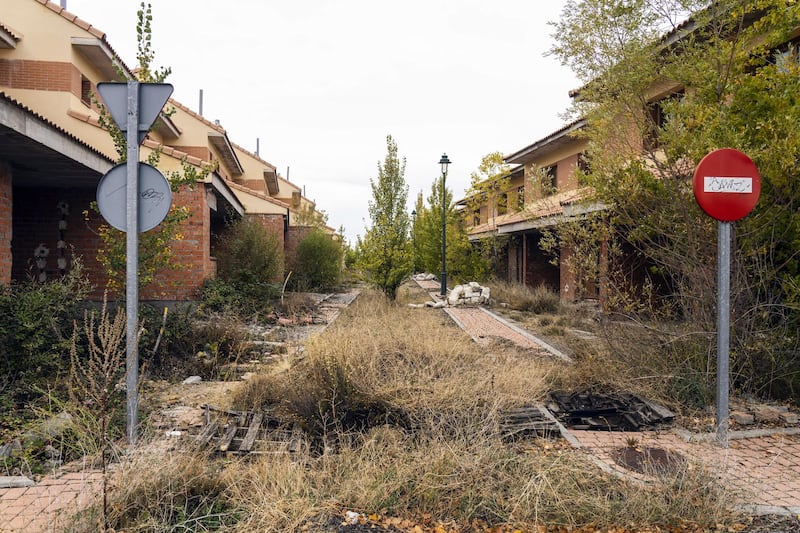 Road signs stand near abandoned and unfinished residential properties in Bernuy de Porreros, near Segovia, Spain, on Monday, Oct. 15, 2018. The volume of residential mortgages sold in Spain peaked in late 2005 before hitting a low in 2013. Photographer: Angel Navarrete/Bloomberg
