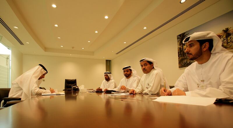 Dubai, United Arab Emirates, Aug 17 2011, FNC Register-  (left) Candidate Ahmed Shakeri sits with election officals who answer any questions the candidate may have regarding the election. Today was the last day to register for the FNC Election which will be held next month , Sept 2011. Candidates had present documentation and pay election fees. Mike Young / The National