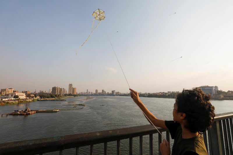 A boy flies a kite on a bridge over the Nile in Cairo, Egypt. Reuters