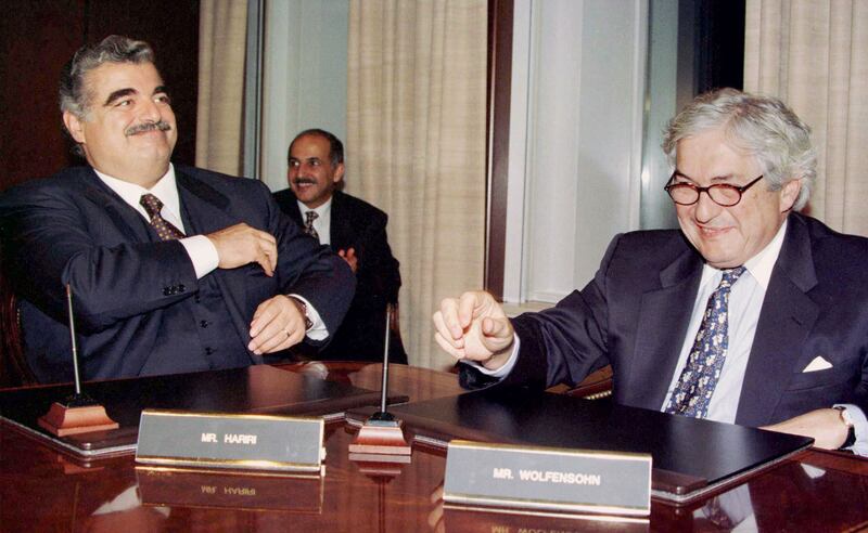 Former Lebanese prime minister Rafik Hariri and Wolfensohn sign agreements at the World Bank's headquarters on December 16, 1996. Reuters