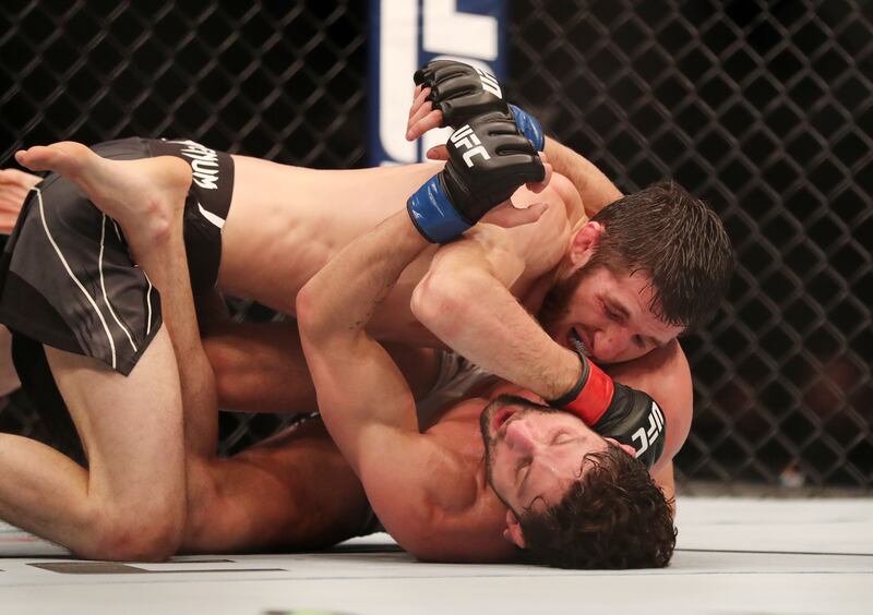 UFC flyweight bout between Allan Nascimento (blue) and Tagir Ulanbekov (red) at UFC 267. Etihad Arena, Yas Island, Abu Dhabi