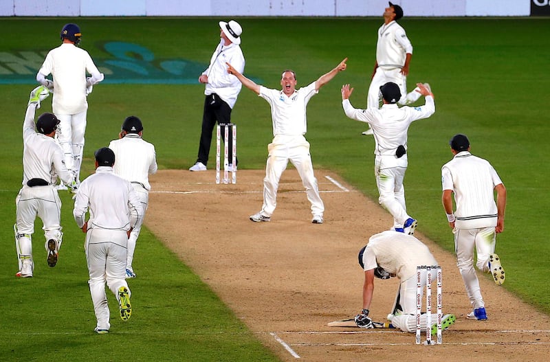 Cricket - Test Match - New Zealand v England - Eden Park, Auckland, New Zealand, March 26, 2018. New Zealand's Todd Astle celebrates with team mates after dismissing England's James Anderson to win the match on the fifth day of the first cricket test match.    REUTERS/David Gray