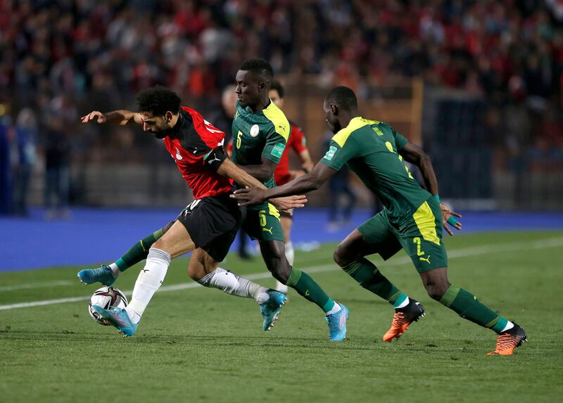 Mohamed Salah of Egypt is tackled by Idrissa Gueye and Saliou Ciss of Senegal. Getty