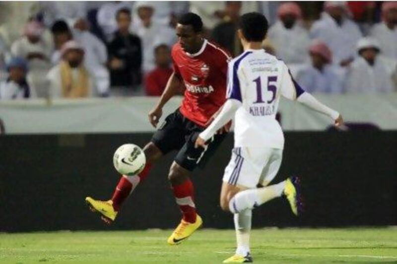 Al Ain´s Khaled Abdulrahman, white, and Al Ahli´s Ahmed Khalil fight for the ball.