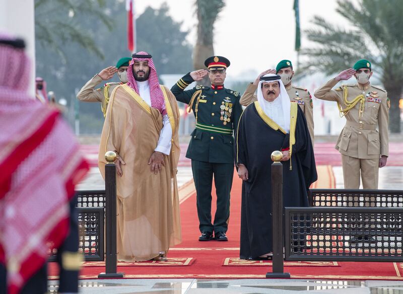 King Hamad and military personnel welcome Prince Mohammed at Sakhir Palace. AFP