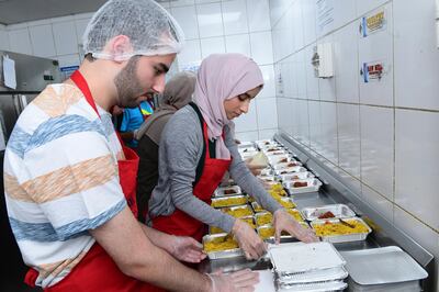 A team of volunteers help provide thousands of labourers with iftar meals during Ramadan. Courtesy Mohammed Bin Rashid University