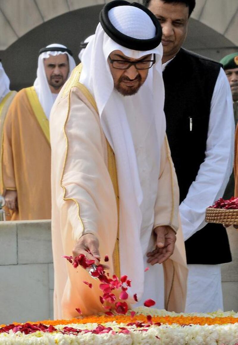 Abu Dhabi Crown Prince Sheikh Mohammed bin Zayed throws rose petals as he pays tribute at Raj Ghat, the memorial to the father of the Indian nation Mahatma Gandhi, in New Delhi. Money Sharma / AFP Photo