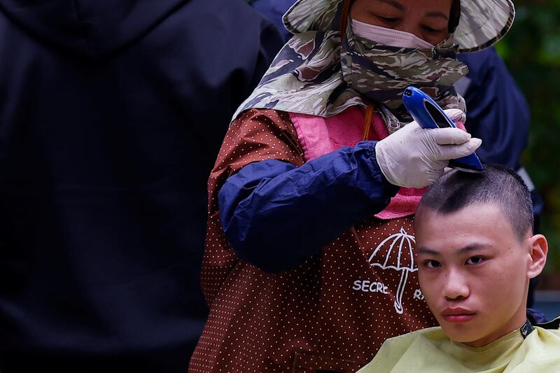 A new recruit has his head shaved at the start of Taiwan's one-year compulsory military service, after the conscription period was extended from four months, in Taichung. Reuters